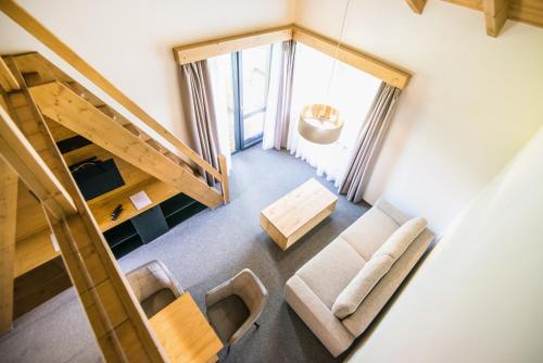 an overhead view of a living room with a staircase and chairs at Apartmány Tatry Žiarce in Liptovský Mikuláš