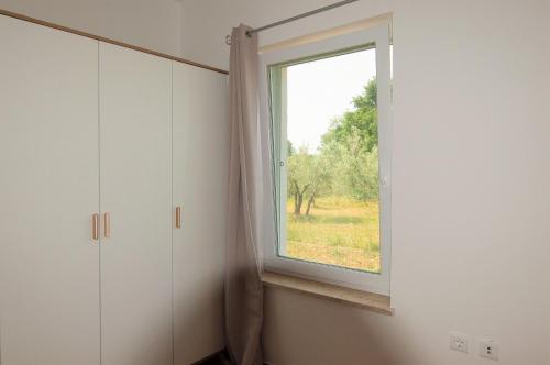 a window in a room with a view of a field at Casa Pepe in Pula