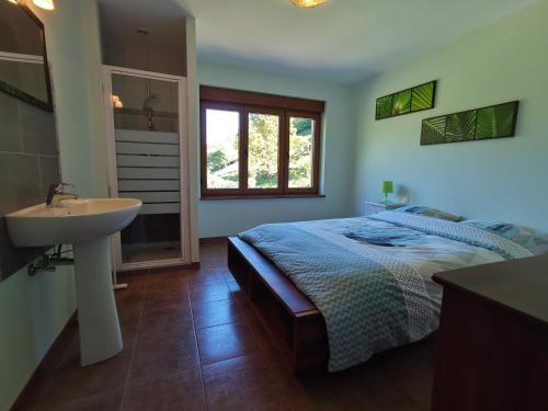 a bathroom with a bed and a sink in a room at Gîte Saint Ludan in Rombach-le-Franc