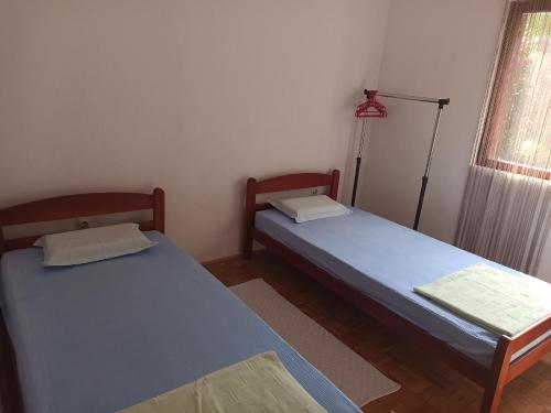 a room with two beds and a lamp in it at Uroš in Kamenari