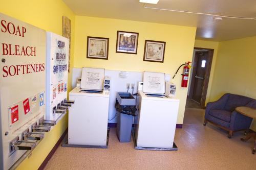 a hospital room with two counters and a waiting room with a chair at Travelodge by Wyndham Elko NV in Elko