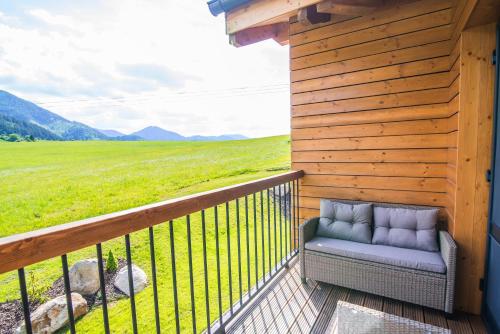 a porch of a cabin with a couch on it at Apartmány Tatry Žiarce in Liptovský Mikuláš