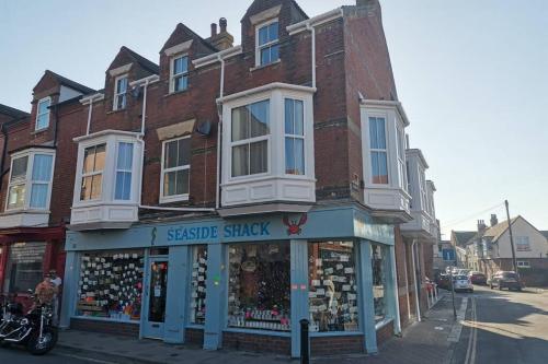 a store on a street with a brick building at BERNARDS HIDEOUT in Cromer