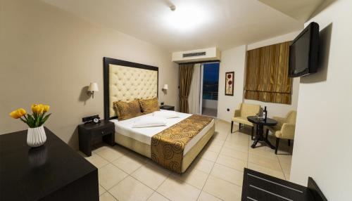 a hotel room with a bed and a television at Amalias Hotel in Kourouta