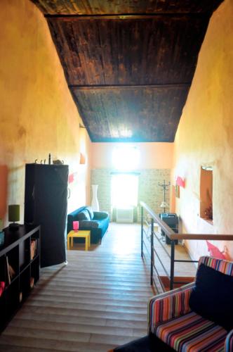a living room with couches and a wooden ceiling at Ruine-Motovun KH in Motovun