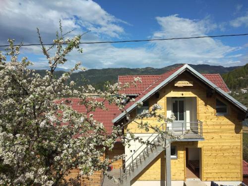 a yellow house with a red roof at Tara lake apartments in Jevtići