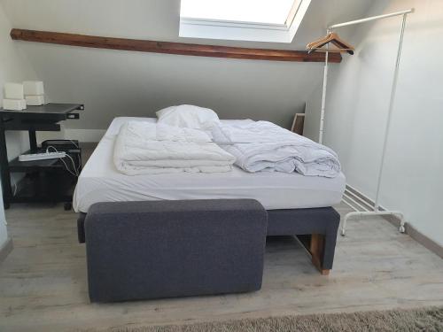 a bed sitting in a room with a window at maison de madame De souter in Sequedin