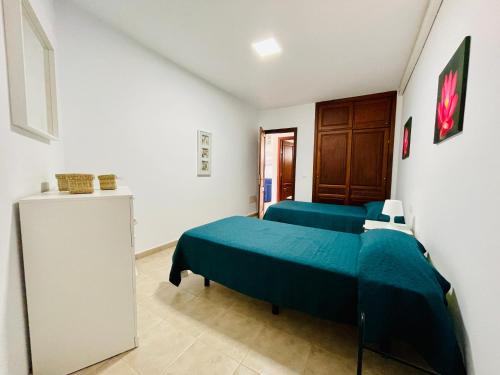 a bedroom with two beds and a cabinet in it at Casa Josefa 1 in Caleta de Sebo
