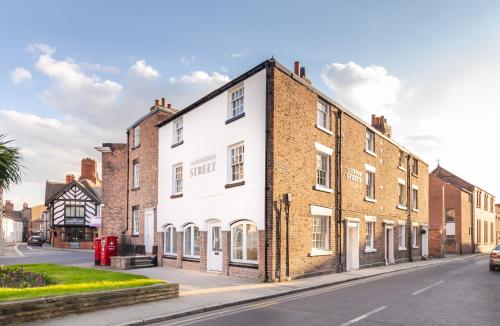a building on the corner of a street at 14-16 Grosvenor Street Stylish Apartments - Chester in Chester