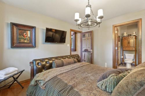 a bedroom with a bed and a tv on the wall at The Funky Monkey Inn in Afton