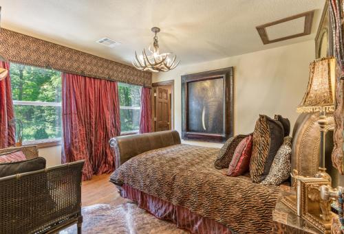 a bedroom with a bed and two windows at The Funky Monkey Inn in Afton