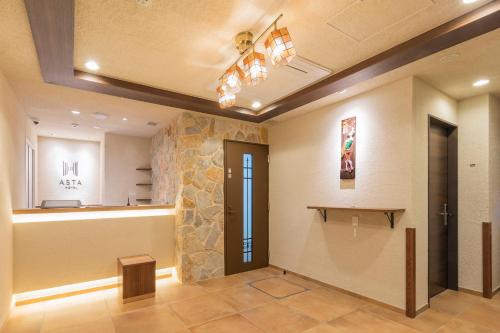 a room with a hallway with a counter and a door at Asta Hotel in Tokyo