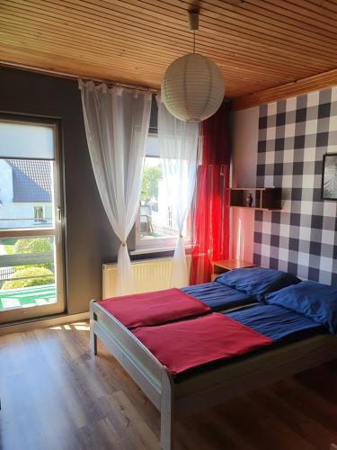 a bedroom with a bed and a window at Pokoje Gościnne Jolanta in Ostrowo