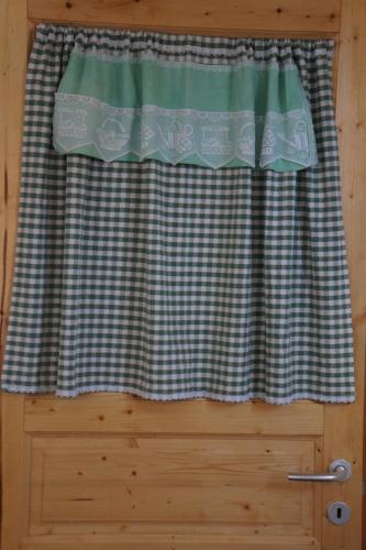 a window with a checkered curtain on a door at antonella home in Brindisi