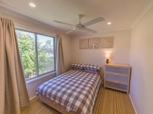 a bedroom with a bed and a window at 17 Broadbeach Drive in Normanville