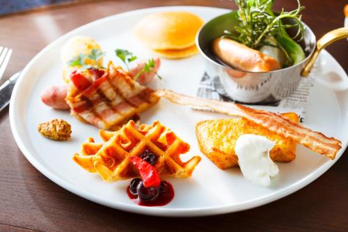 a white plate with waffles and waffleergy at Hyatt Regency Yokohama in Yokohama