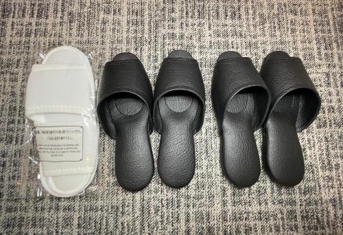 three pairs of shoes and a pair of slippers at Asta Hotel in Tokyo