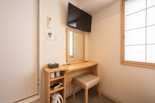 a room with a desk with a mirror and a chair at Fuji Hotel Kyoto Gojo in Kyoto
