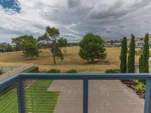 a balcony with a view of a field and trees at Shearers Rest 5 Davey Road in Normanville