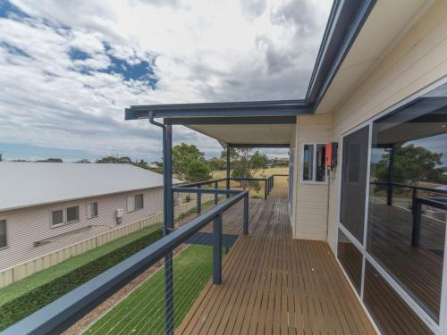 a balcony with a view of a house at Shearers Rest 5 Davey Road in Normanville
