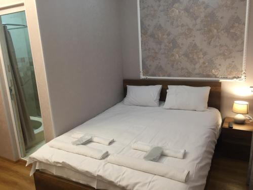 a bedroom with a bed with two towels on it at HOTEL COMFORT in Kutaisi