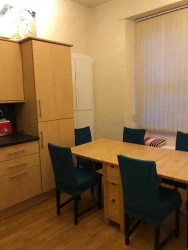 a conference room with a wooden table and chairs at Edinburgh City Holiday Apartments in Edinburgh