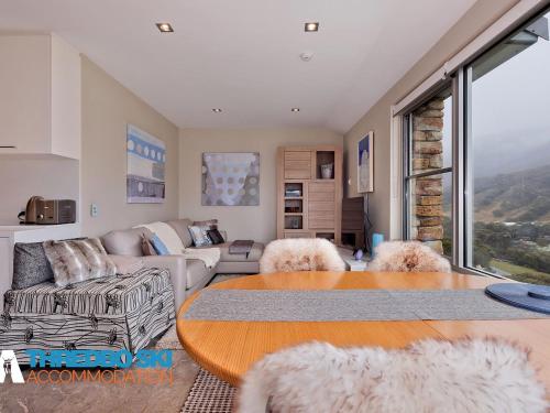 a living room with a couch and a table at The Peak 7 in Thredbo