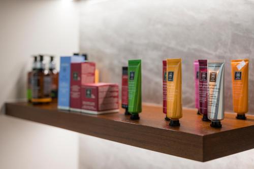 a wooden shelf with books and bottles on it at Hyperion City Hotel & Spa in Chania Town