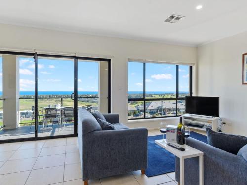 a living room with two couches and a tv at 18 Turnberry Drive in Normanville