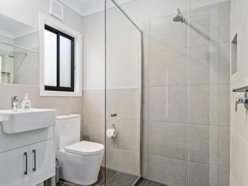 a bathroom with a shower and a toilet and a sink at 8 Huntingdale Drive in Normanville