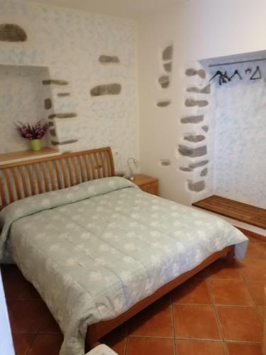 a bedroom with a bed and a wall with wine bottles at I Limoni 2 in La Spezia