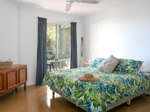 a bedroom with a bed with a hat on it at Seven on Scenic - 7 Scenic View Drive, Second Valley in Second Valley