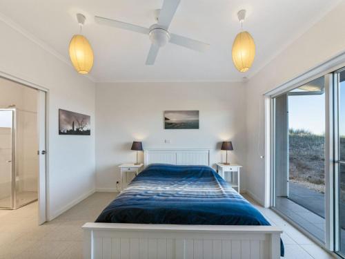 a bedroom with a bed and a large window at Fleurieu Coastal Retreat Lot 150 Myponga Beach in Wattle Flat