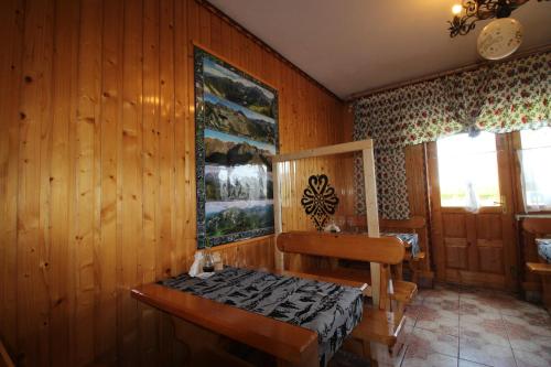 a room with a wooden wall with a bench in it at DW U Wajdy in Białka Tatrzanska