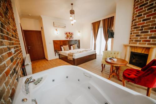 a bathroom with a bath tub and a living room at Sea House Hotel in Agva