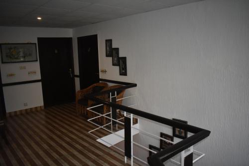 a room with a staircase and a stair case at Elysium 99 in Islamabad