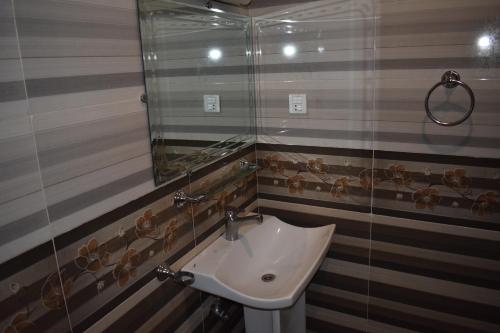 a bathroom with a sink and a mirror at Elysium 99 in Islamabad