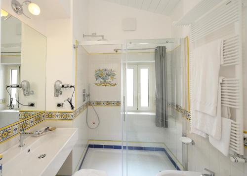 a bathroom with a shower and a sink and a toilet at Boutique Gimagì in Amalfi