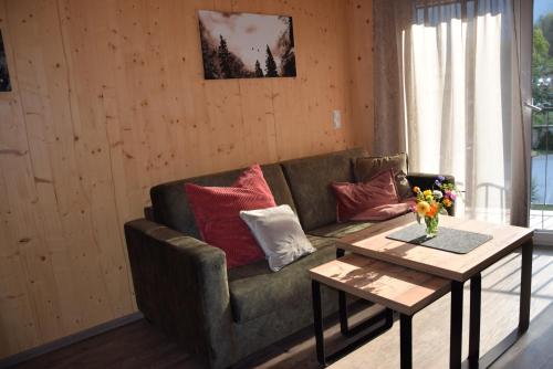 a living room with a couch and a coffee table at Herbst Wohnerlebnis in Lofer