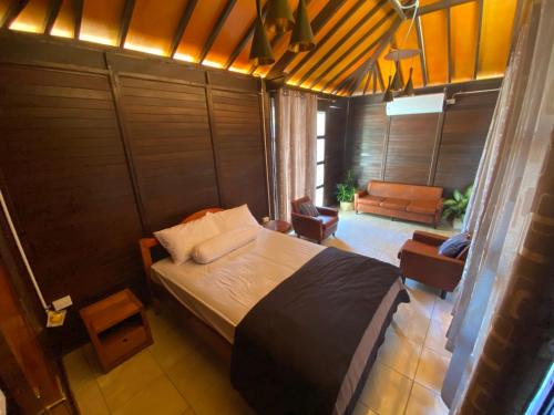 um quarto com uma cama grande num quarto em Compass Atauro Eco Lodge em Beloi