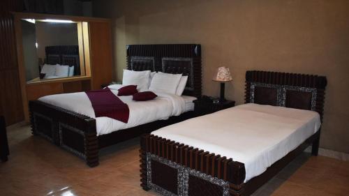 Postelja oz. postelje v sobi nastanitve Manama Hotel