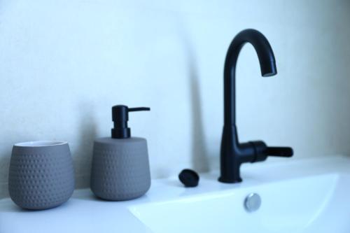 a bathroom counter with a sink and a faucet at Luxury 3&4 Bedroom new apartments - close to the Beach & Bahai Gardens in Haifa