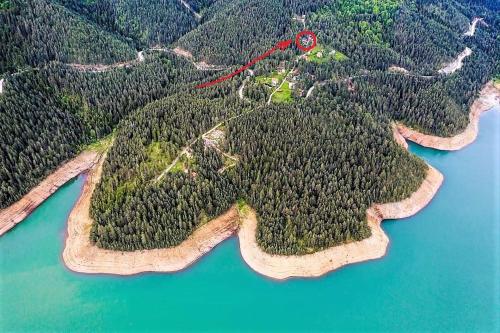 an island with a red house on top of it at SVETLA U PLANINI in Bajina Bašta