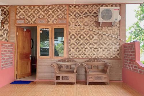 a house with a bench in front of a door at AA BUNGSU Syariah Balekambang Ciletuh Sukabumi RedPartner in Cilowa