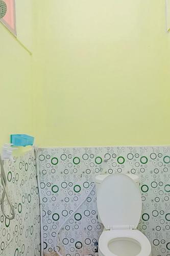 a bathroom with a toilet and a shower curtain at AA BUNGSU Syariah Balekambang Ciletuh Sukabumi RedPartner in Cilowa