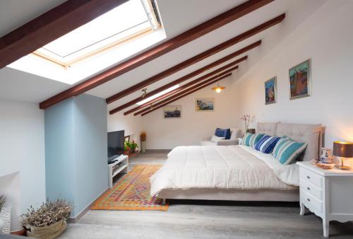 a bedroom with a large bed and a television at Vanilla in Izola