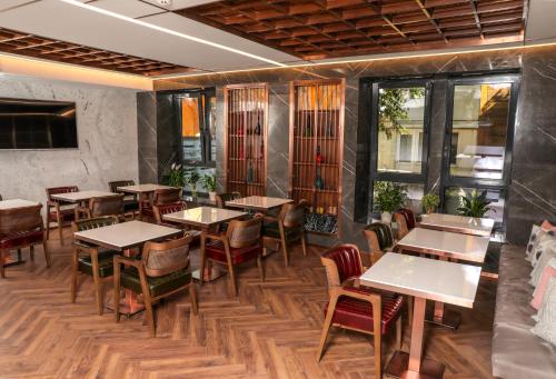 a restaurant with tables and chairs in a room at Henna Hotel Istanbul in Istanbul