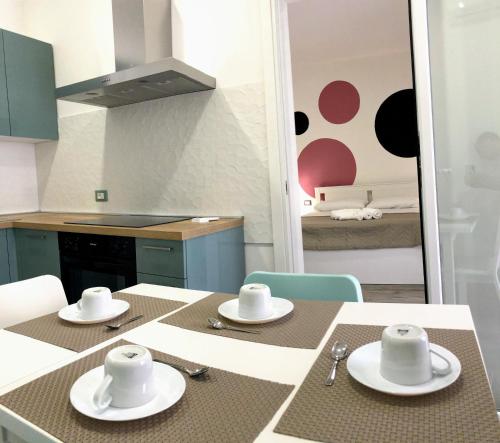 a kitchen with a table with hats on it at Casa Med in Marina di Ragusa