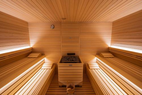a small sauna with a stove in the middle at Lake Front Hotel Mirage in Riva del Garda