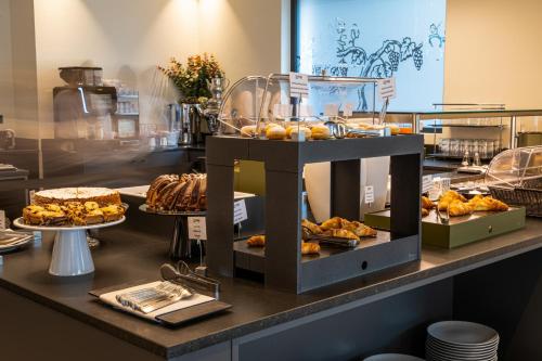 a buffet line with various types of food on display at Lake Front Hotel Mirage in Riva del Garda